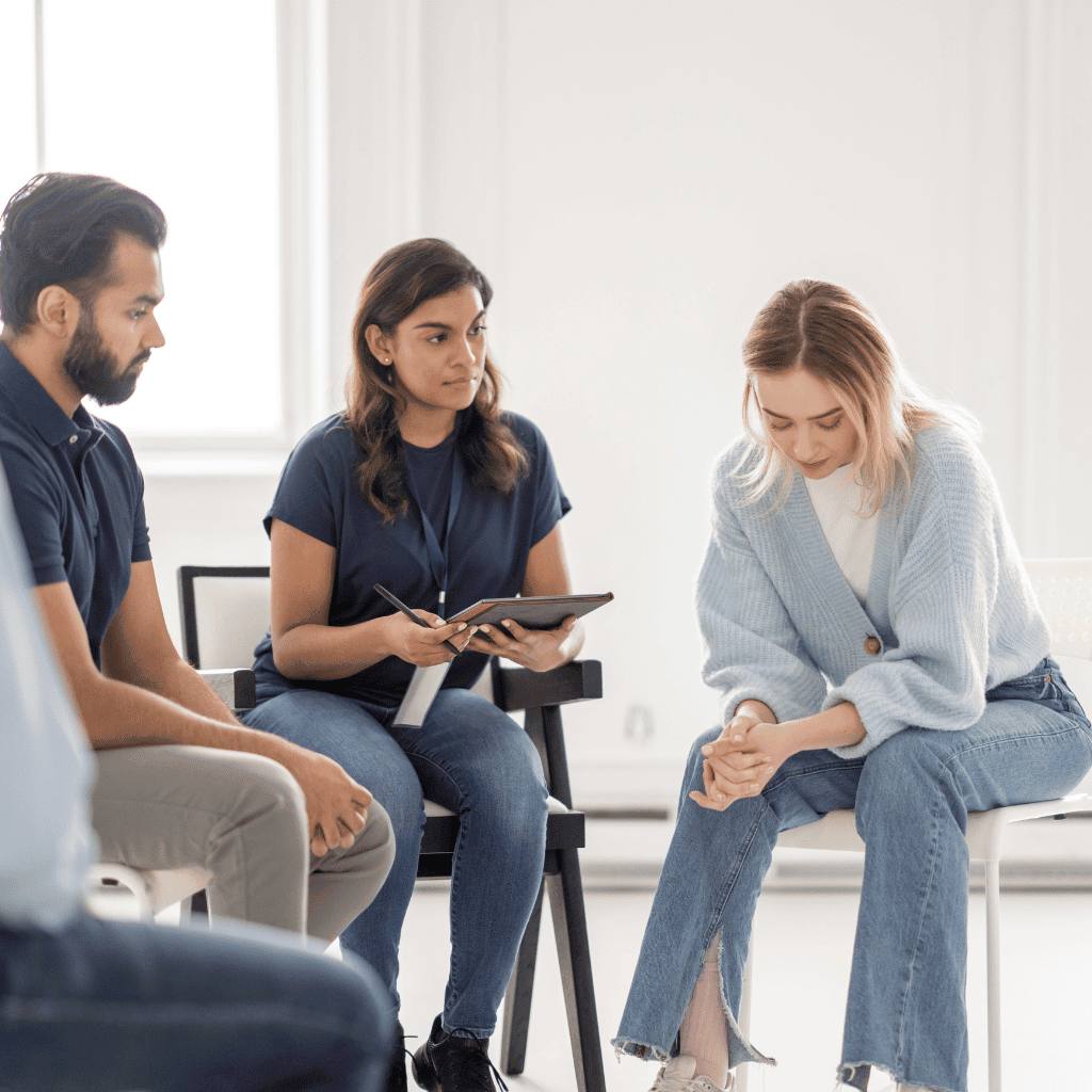 Woman receiving support in a group therapy session